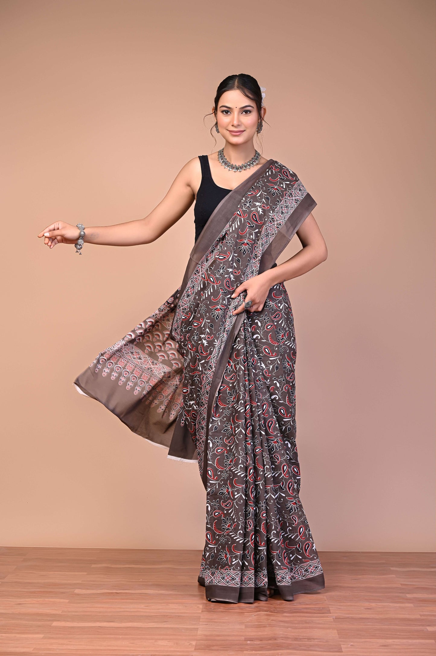 Elegant Brown Ajrakh Printed Cotton Mul Saree worn by a model showcasing its exquisite design and soft fabric.