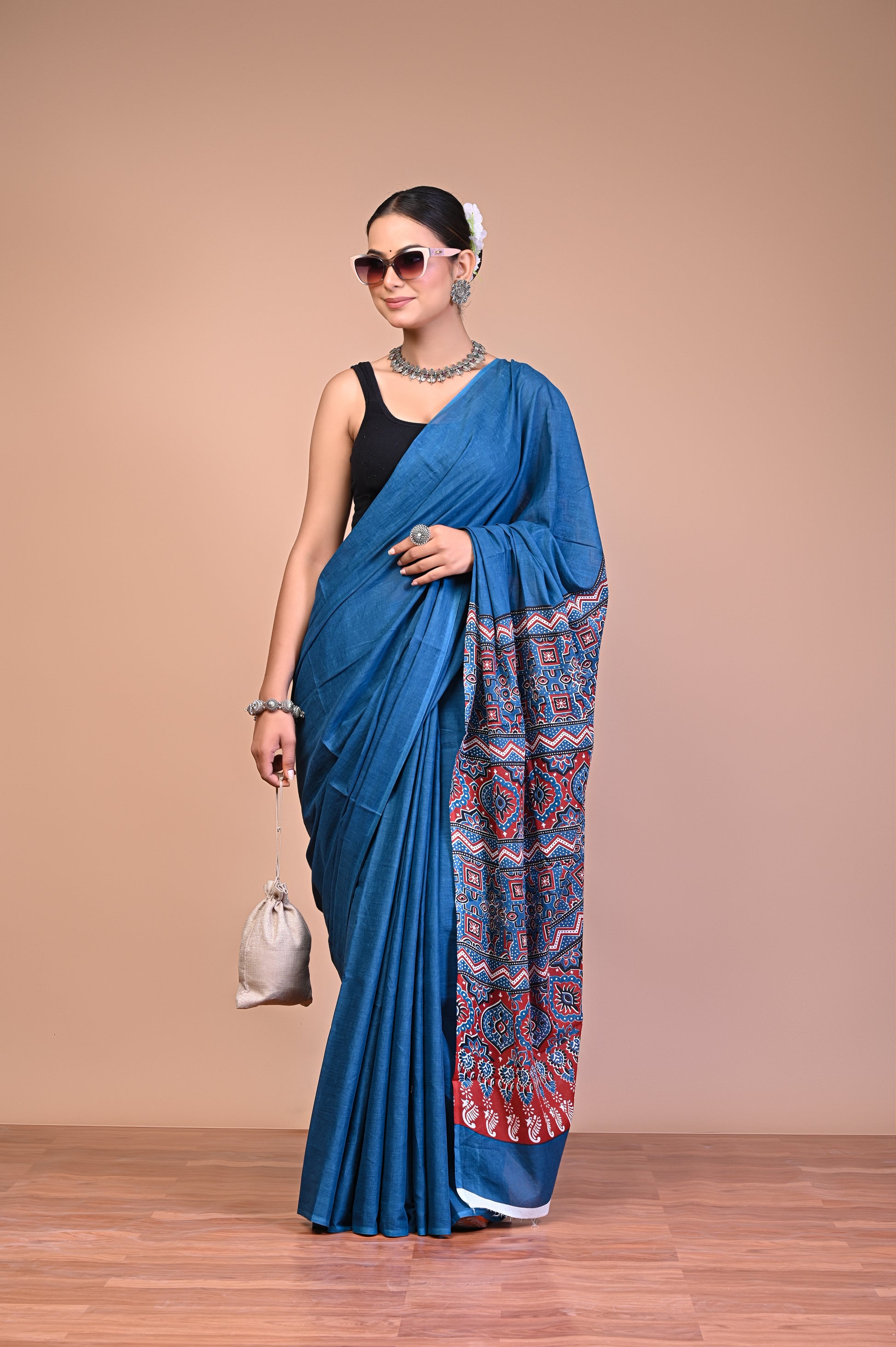 Elegant Blue Ajrakh Print Cotton Mul Saree worn by a model, showcasing its floral and geometric motifs.