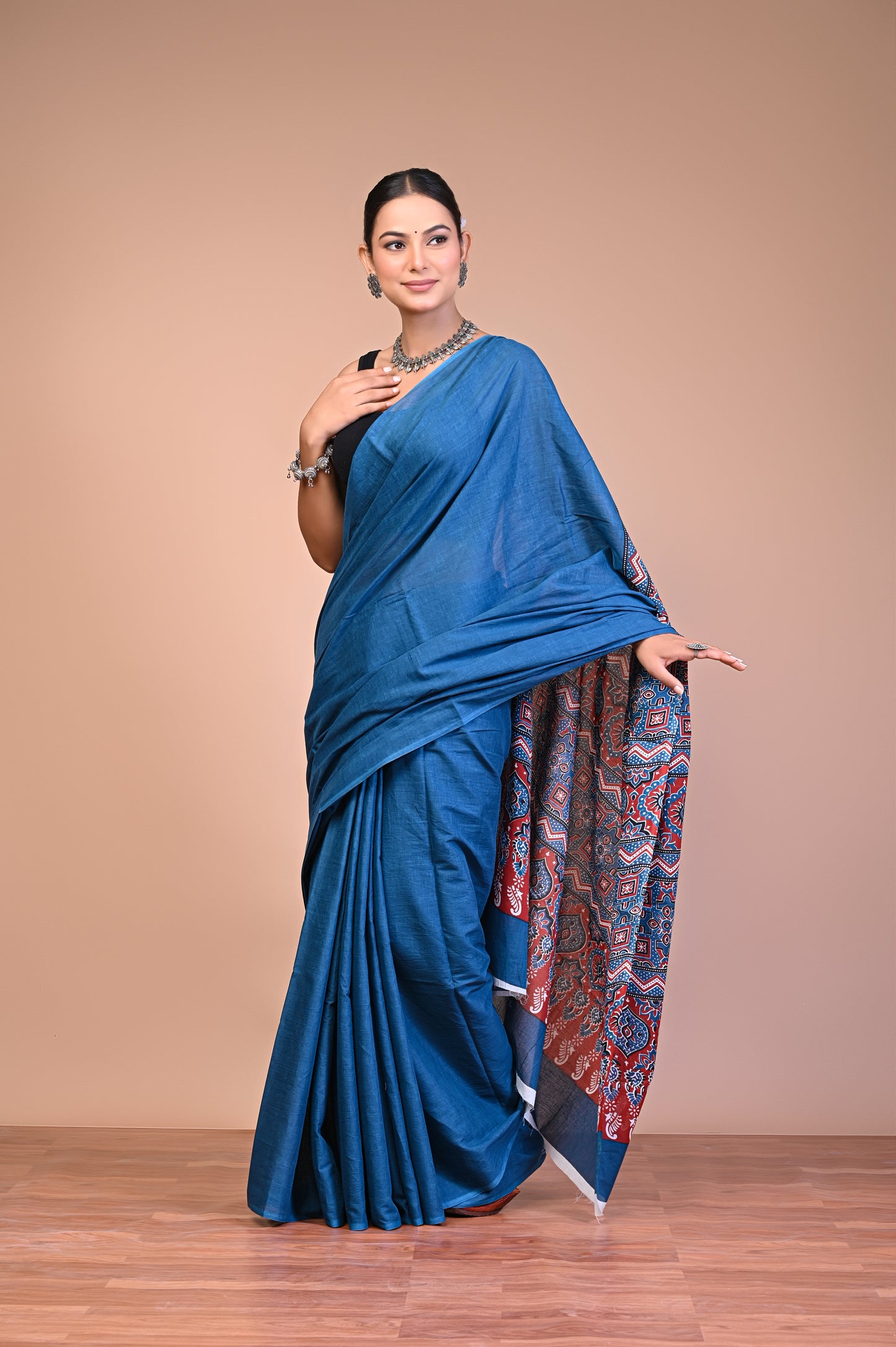 Elegant Blue Ajrakh Print Cotton Mul Saree worn by a model, showcasing intricate design and rich color.