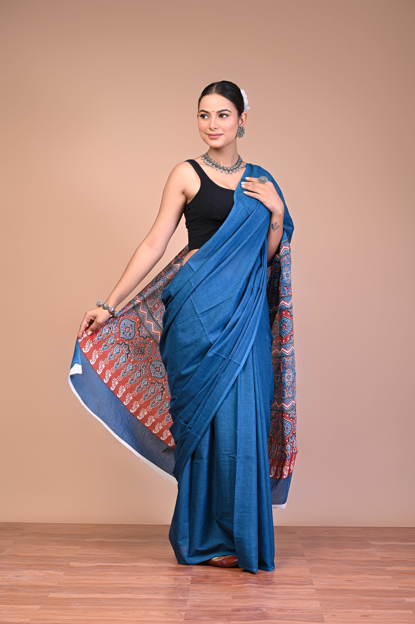 Elegant Blue Ajrakh Print Cotton Mul Saree worn by a model, showcasing floral and geometric motifs.
