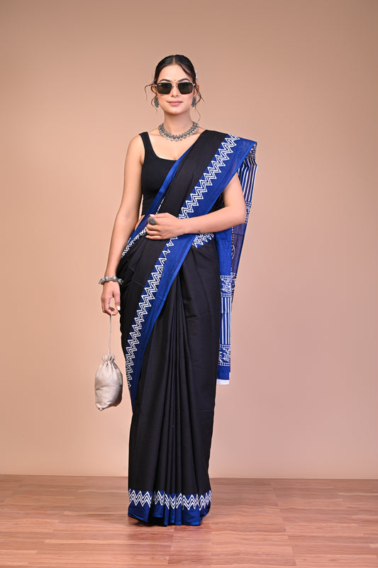 Elegant Black Blue Zigzag Border Cotton Mul Saree modeled by a woman, demonstrating grace and style.