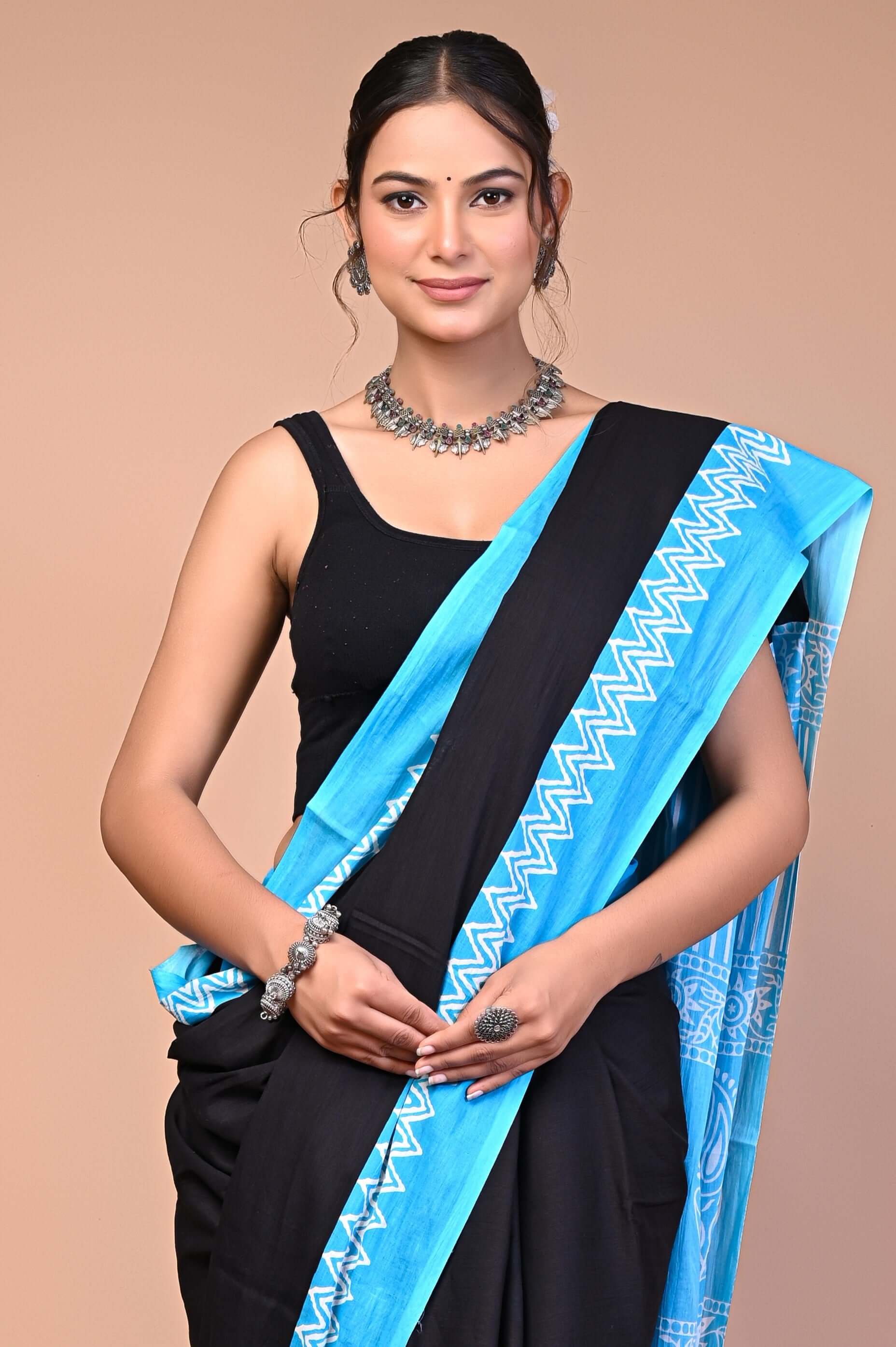 Elegant Black SkyBlue Zigzag Border Cotton Mul Saree worn by a model, showcasing intricate designs and elegance.
