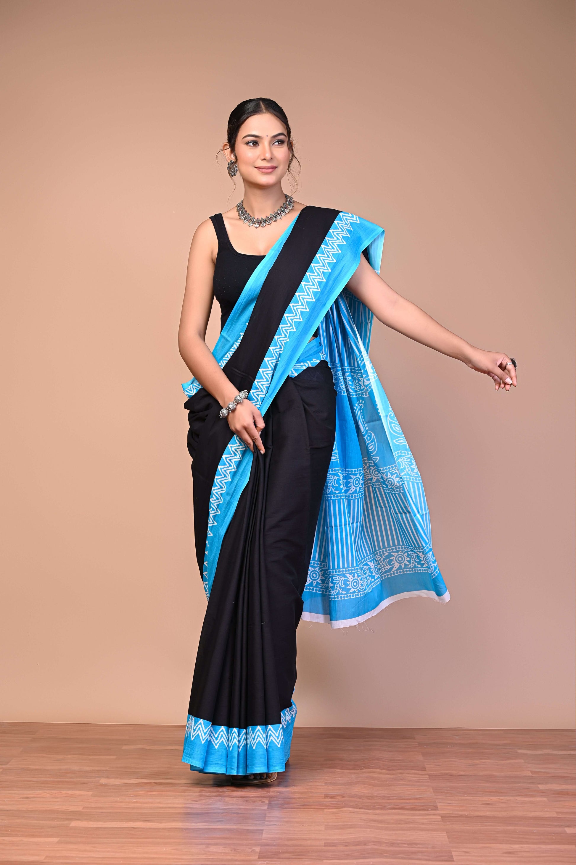 Elegant Black SkyBlue Zigzag Border Cotton Mul Saree being worn by a model, showcasing fine screen printing and intricate details.
