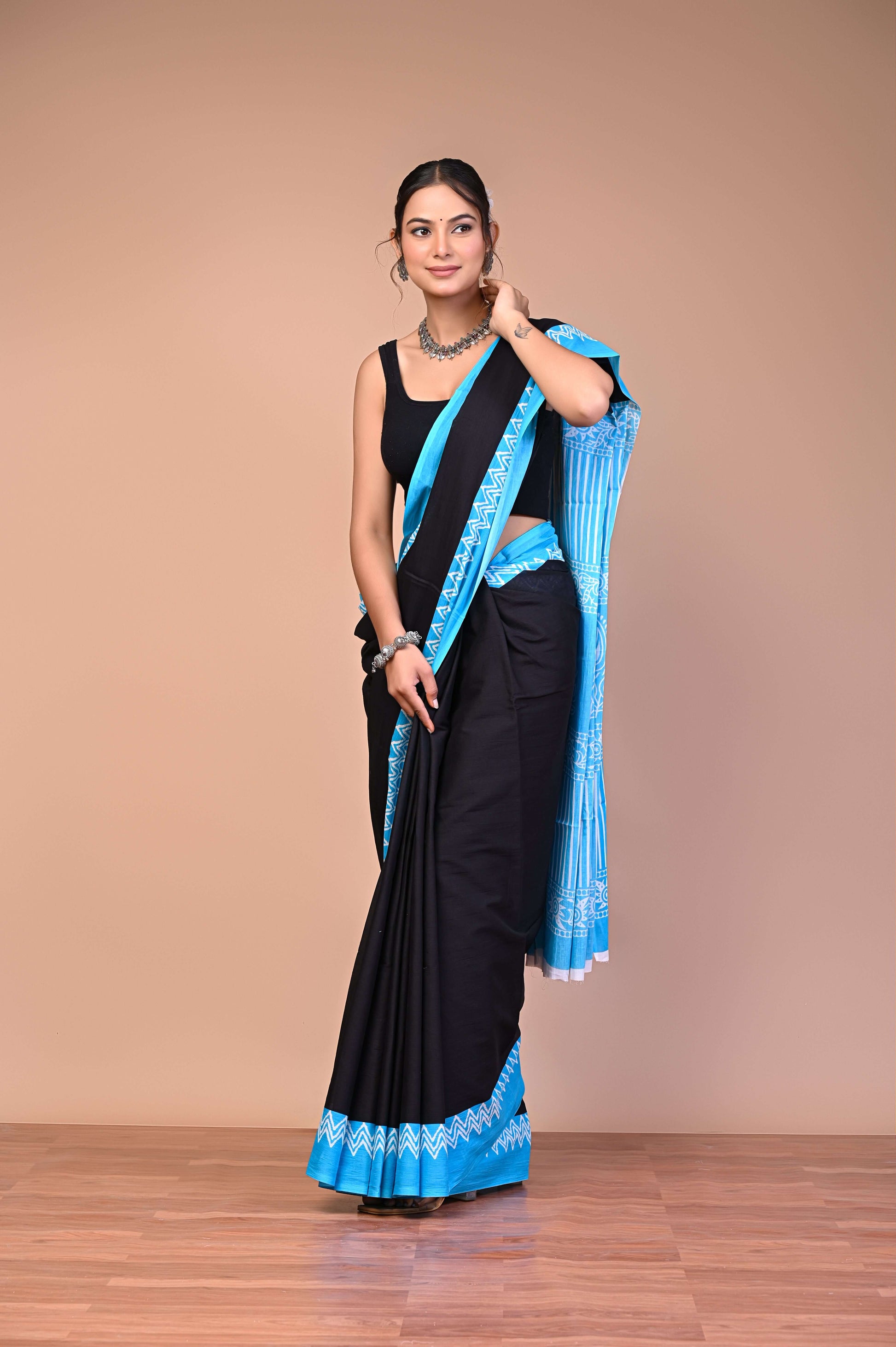Elegant Black SkyBlue Zigzag Border Cotton Mul Saree, Soft Premium Wear showcased on a model.
