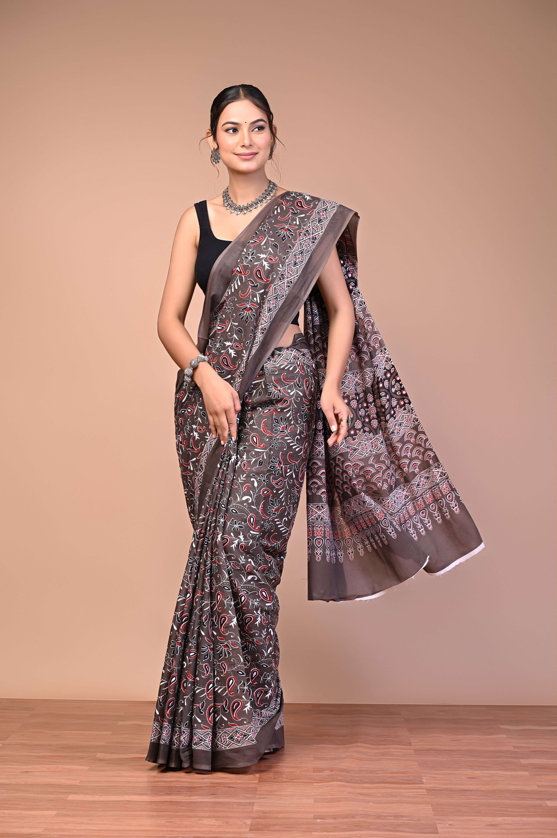 Elegant Brown Ajrakh Printed Cotton Mul Saree showcasing intricate designs and lightweight comfort, perfect for heritage fashion lovers.